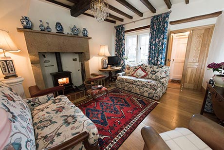 Inside the cosy cottage with exposed beams and a log burner
